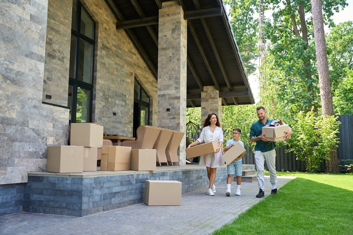 Family moving boxes into a new home