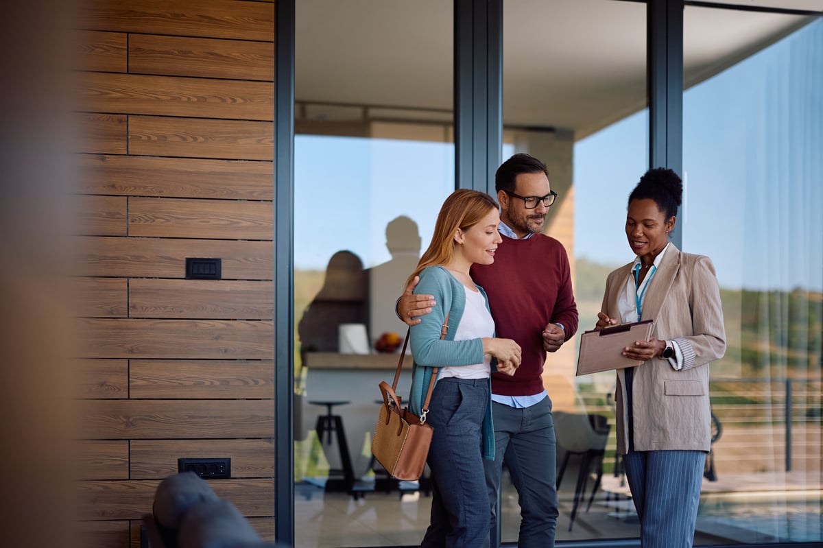 Real estate agent going through housing plans with a couple