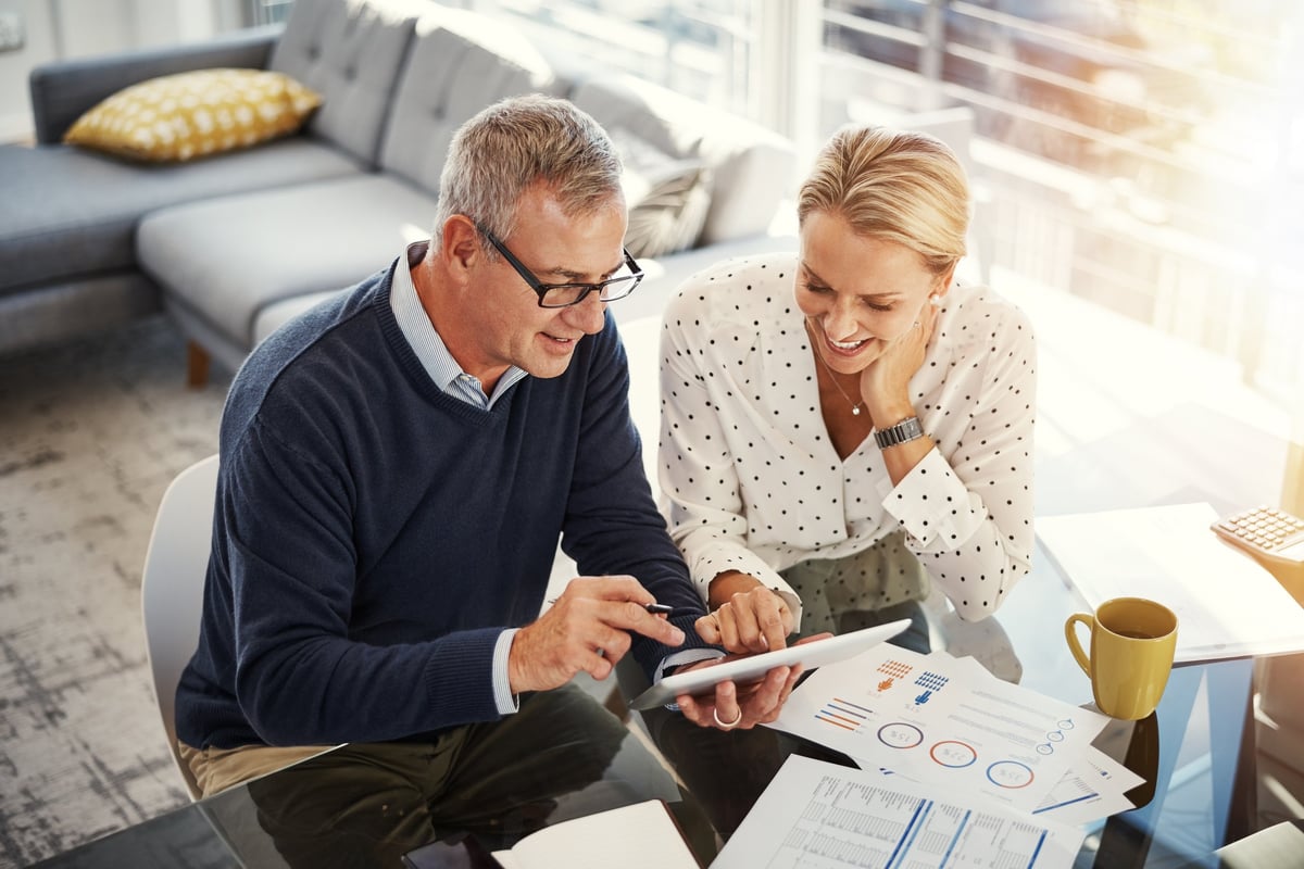 A couple reviewing financial documents for a real estate investment